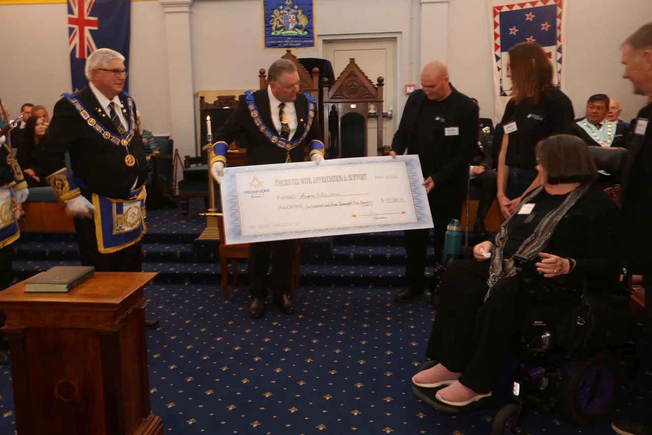 The cheque being handed over to the Access to Adventure team